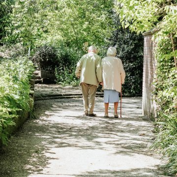 two elderly people going on a walk
